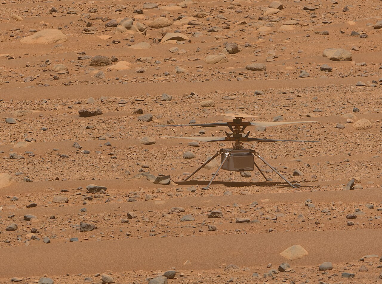 NASA Ingenuity Mars Helicopter resting on the red regolith surface of Jezero Crater on Mars